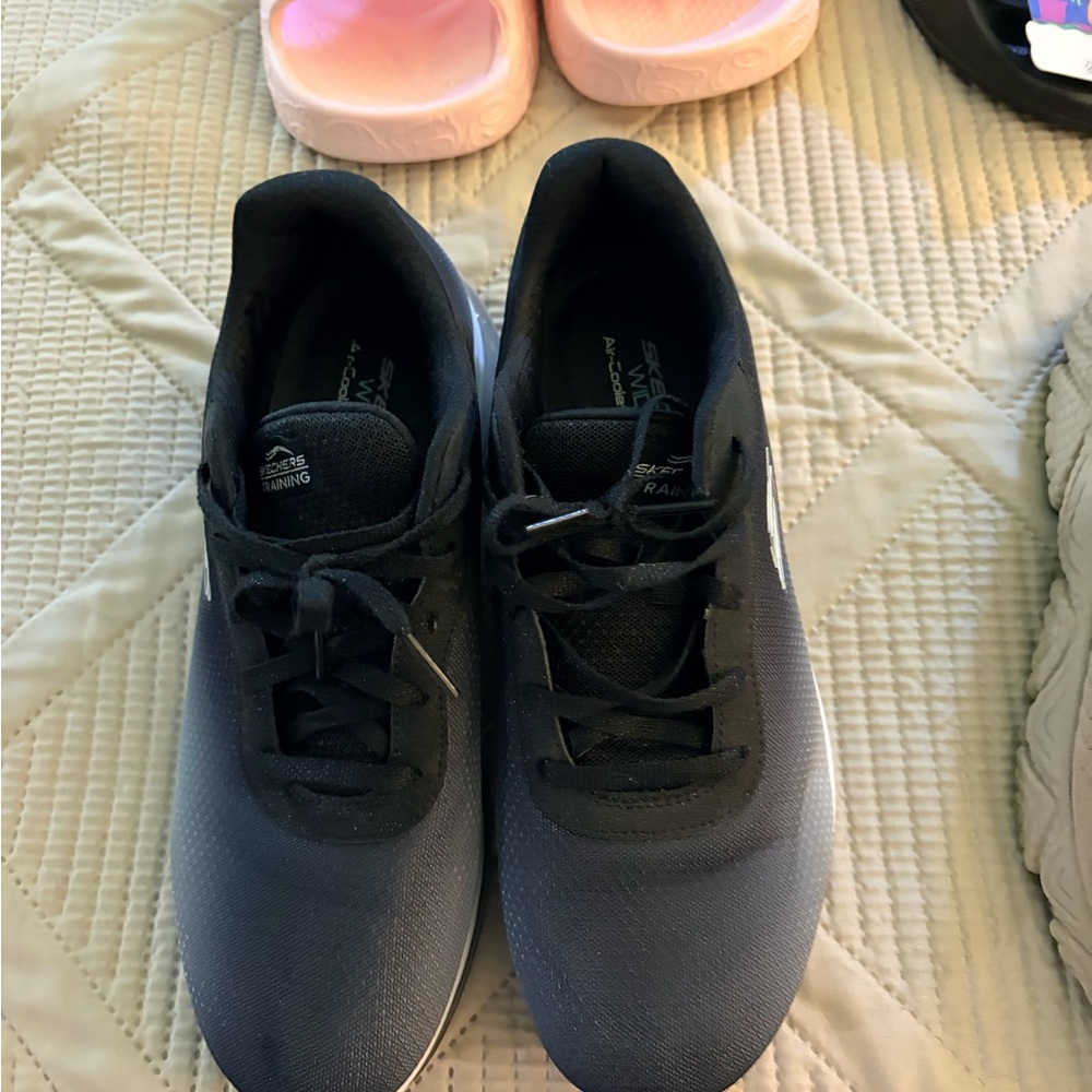 Sketchers women’s black sneakers bundled with tan women’s sneakers.